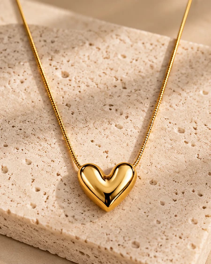 Amour Necklace photographed on a travertine block in warm daylight