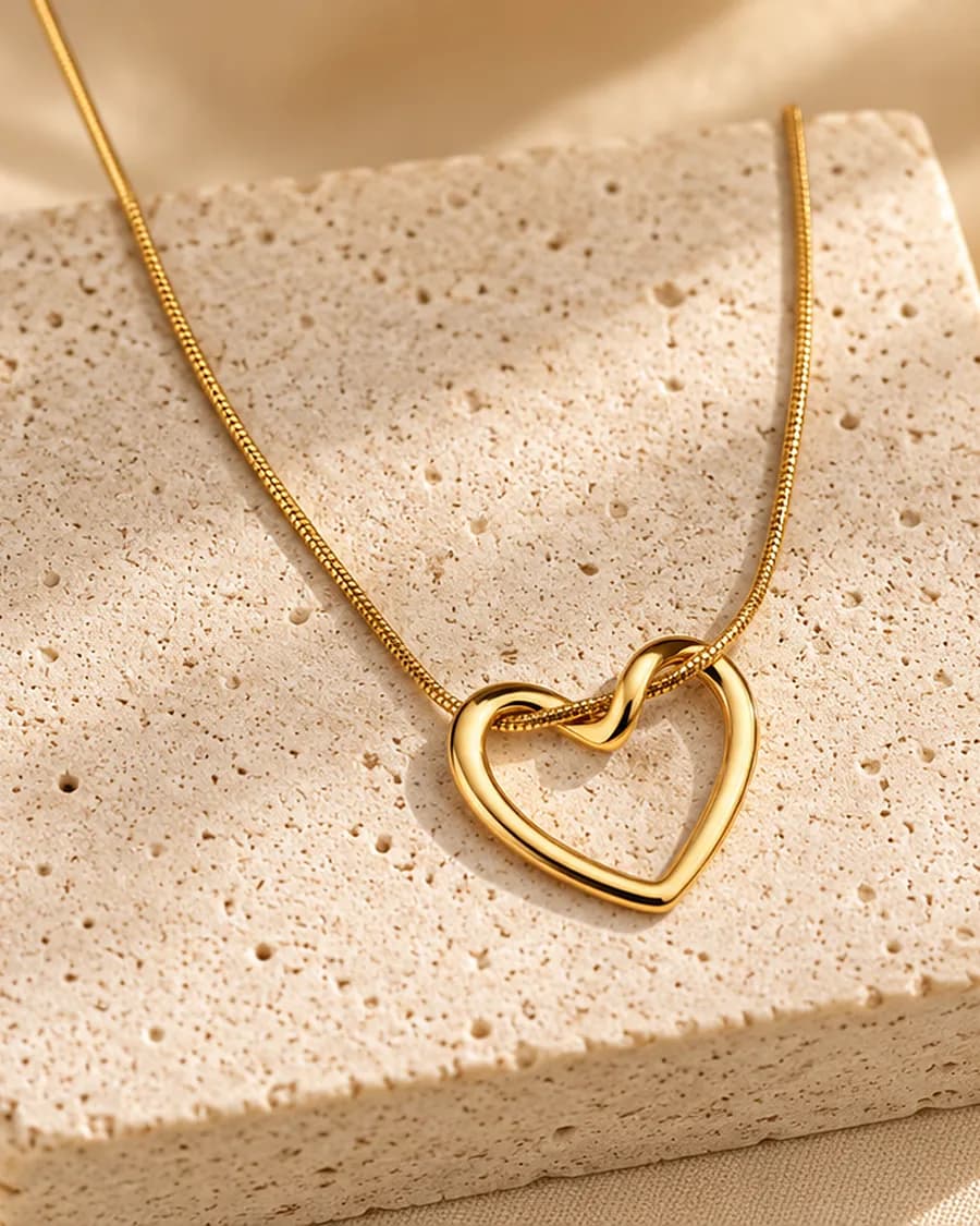 Lovelink Necklace photographed on a travertine block in warm daylight