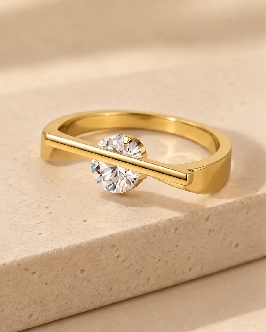 The Axis Solitaire Ring photographed on a travertine block in warm daylight