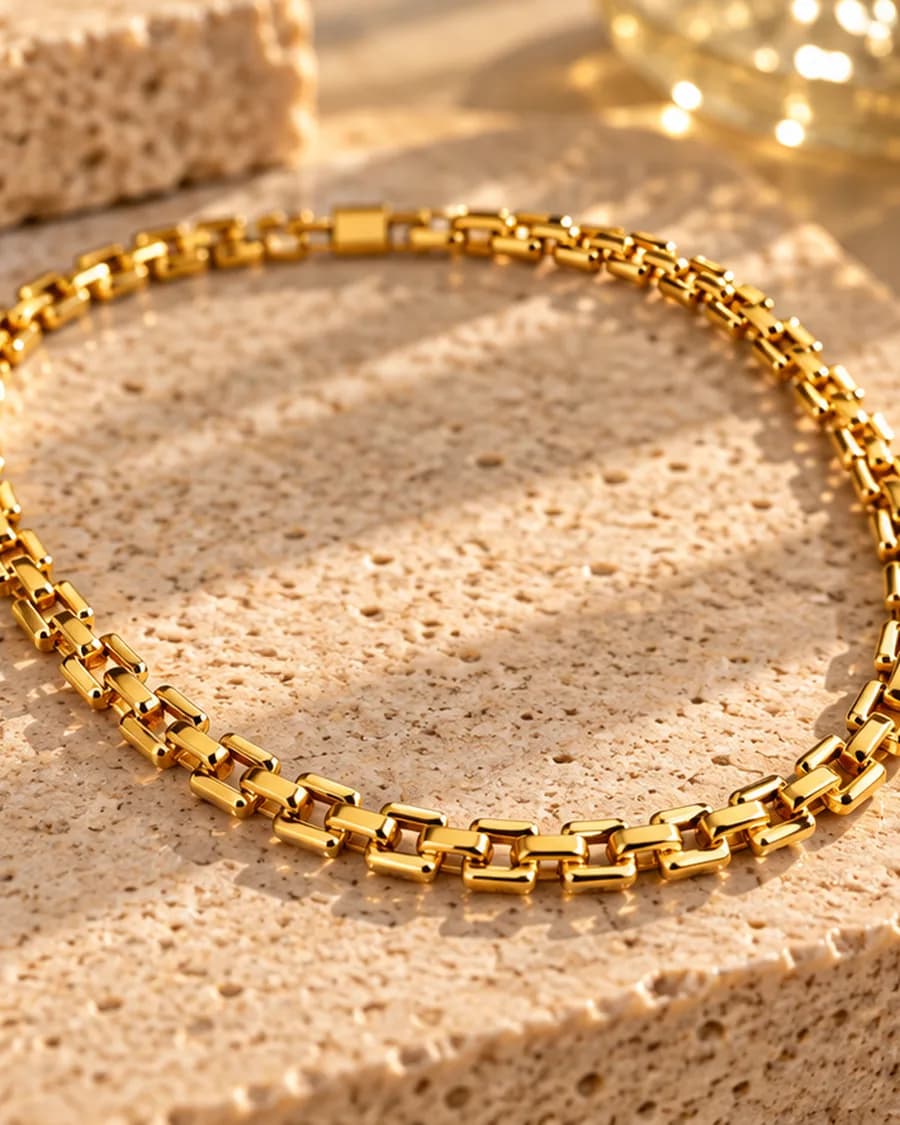 The Cadre Chain photographed on a travertine block in warm daylight