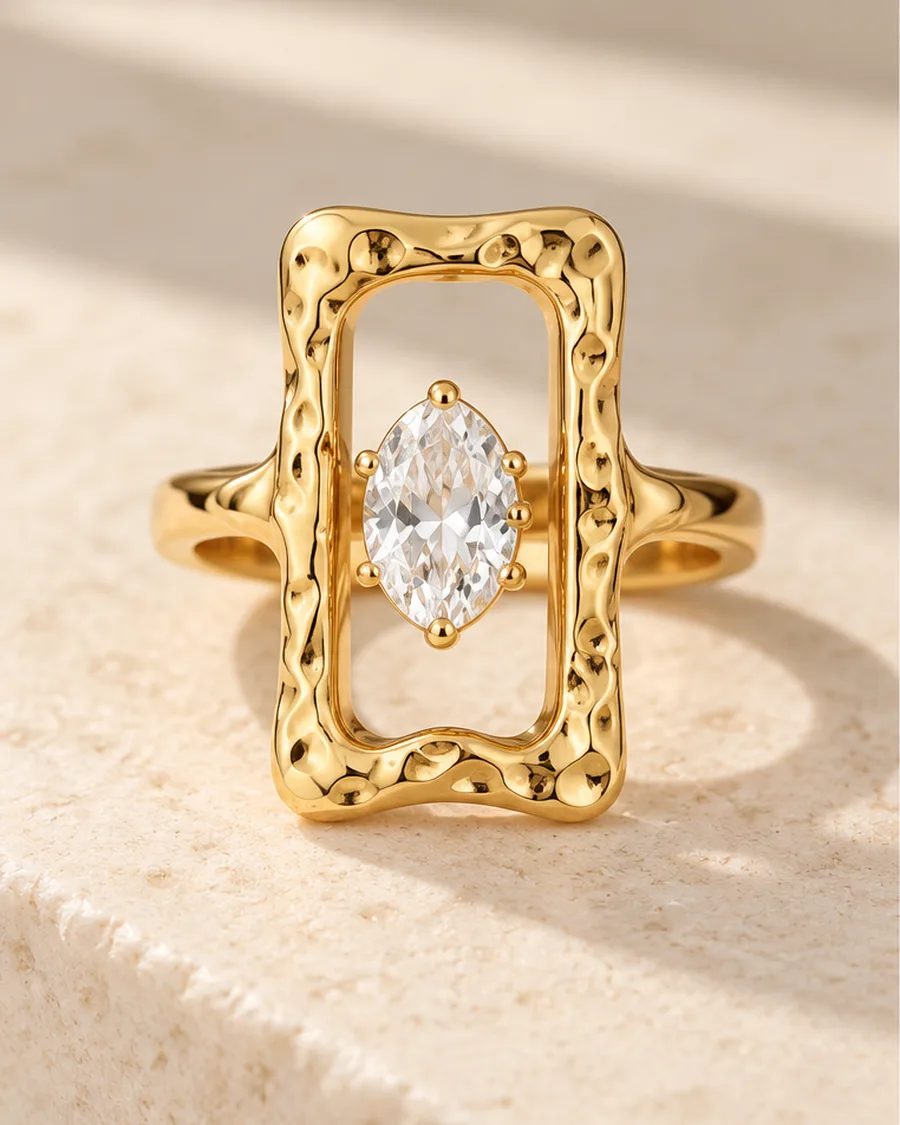 The Cadre Marquise Ring photographed on a travertine block in warm daylight