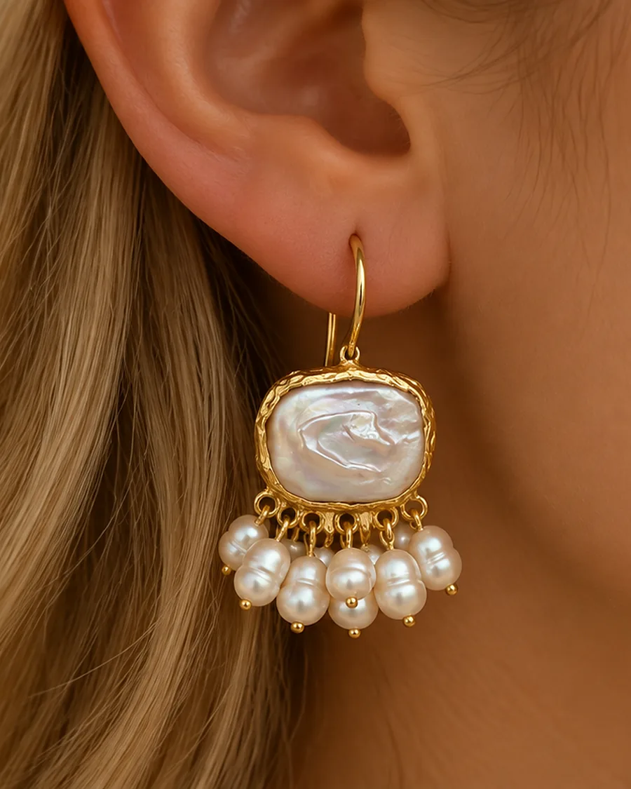 The Cascade Freshwater Pearl Earrings worn, photographed close in natural light