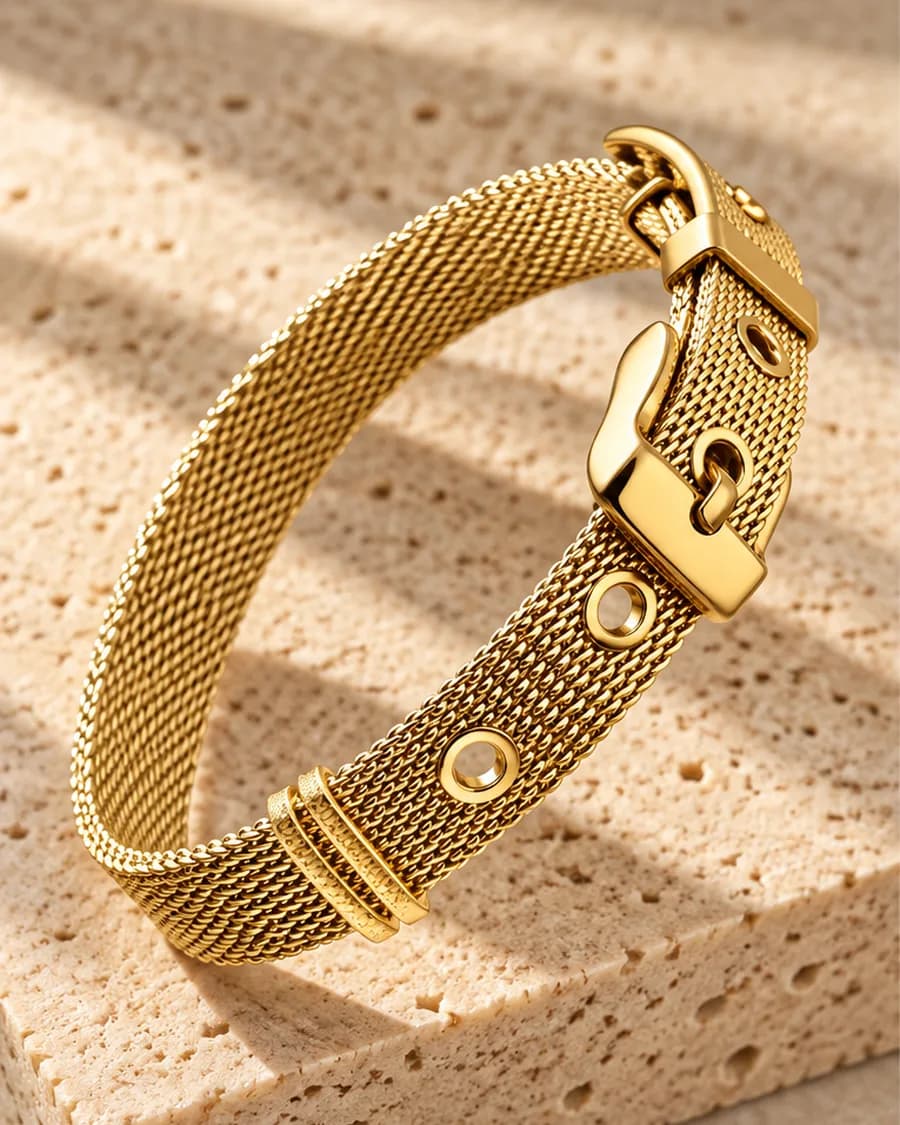 The Cinch Mesh Bracelet photographed on a travertine block in warm daylight
