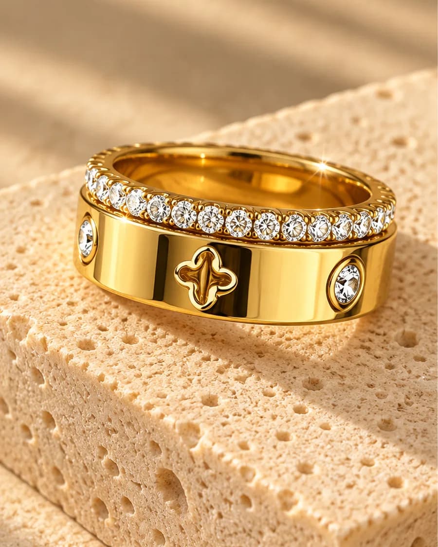 The Clover Éclat Ring photographed on a travertine block in warm daylight