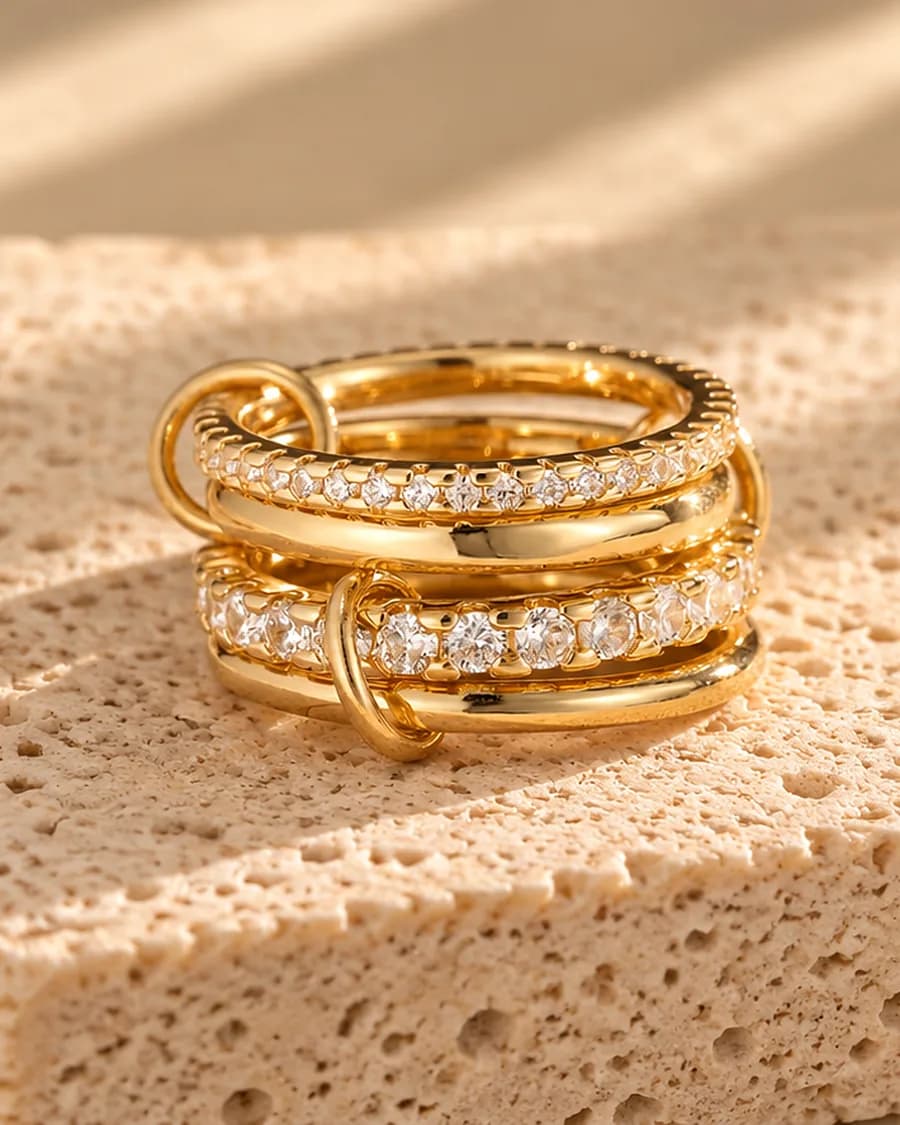 The Éclat Stack Ring photographed on a travertine block in warm daylight