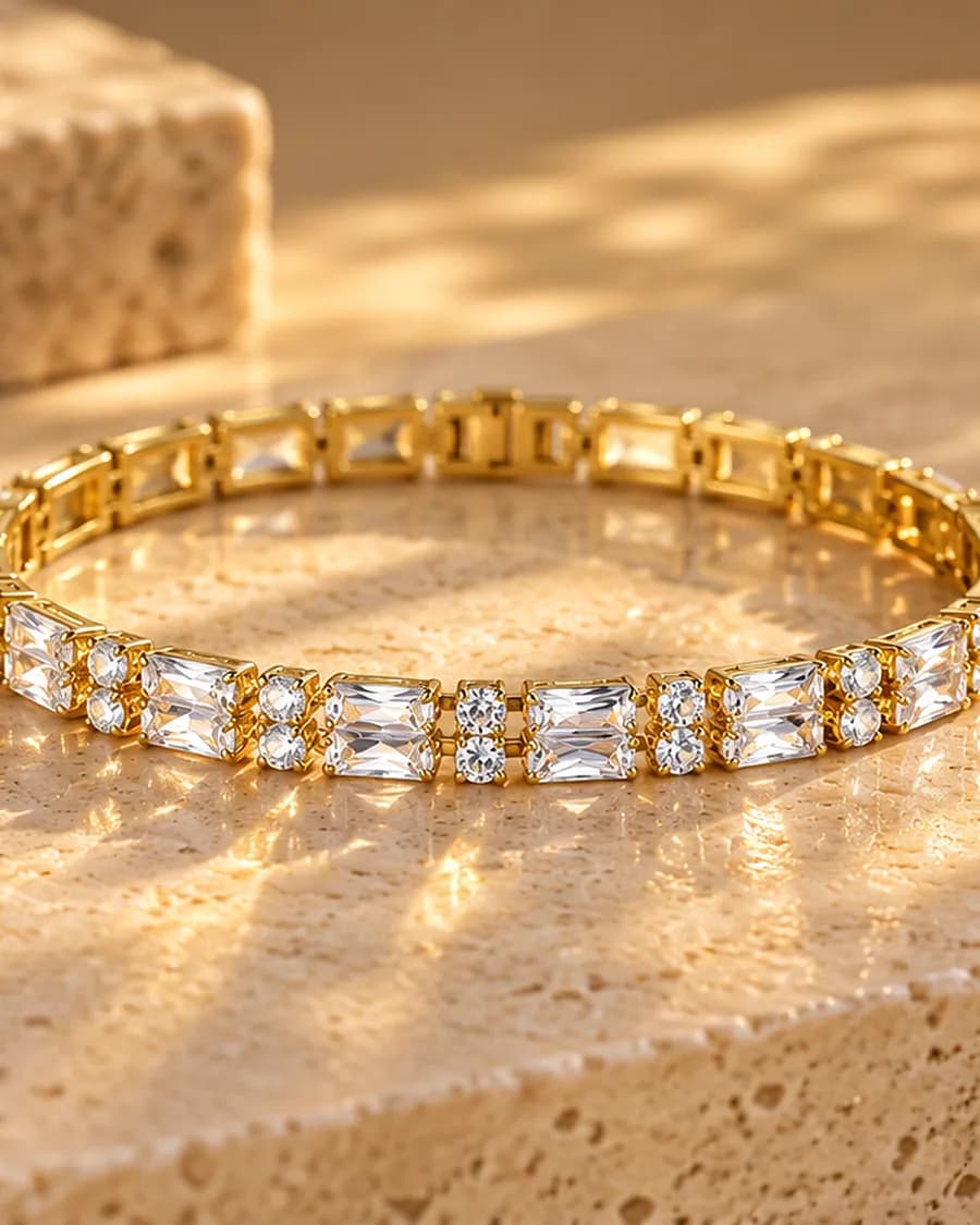 The Éclat Tennis Bracelet photographed on a travertine block in warm daylight