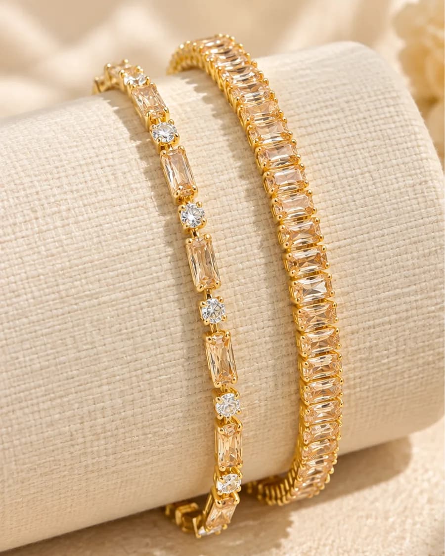 The Éclat Tennis Bracelet Set photographed on a travertine block in warm daylight