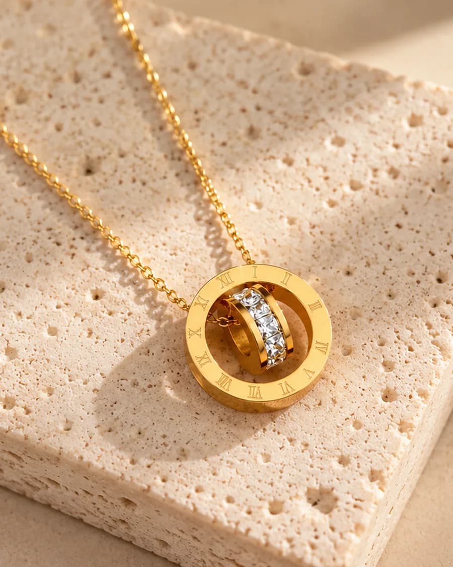 The Éternité Necklace photographed on a travertine block in warm daylight