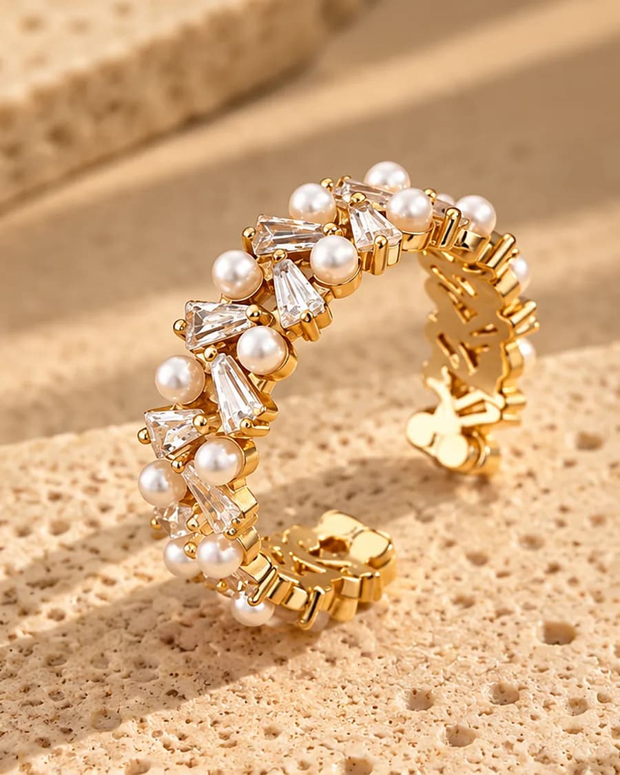 The Lumi Pearl Ring photographed on a travertine block in warm daylight