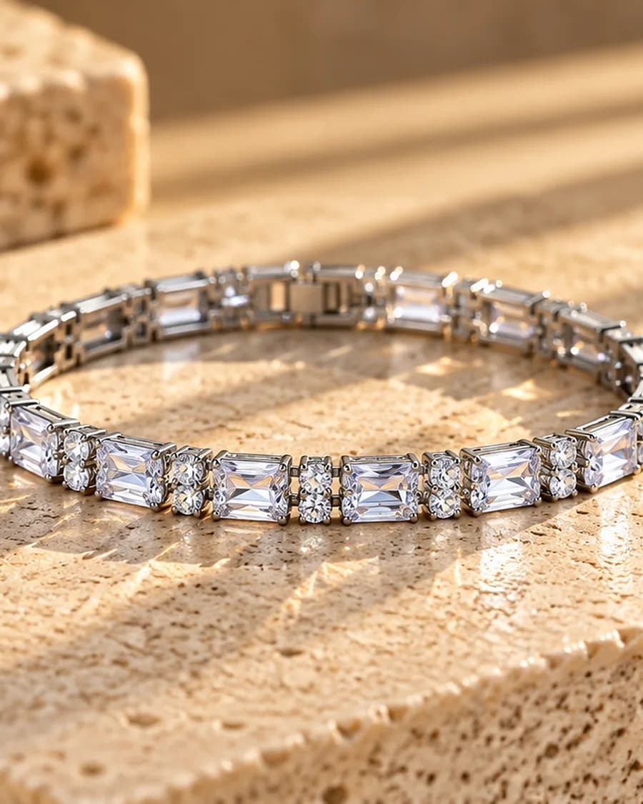 The Moonlight Tennis Bracelet photographed on a travertine block in warm daylight