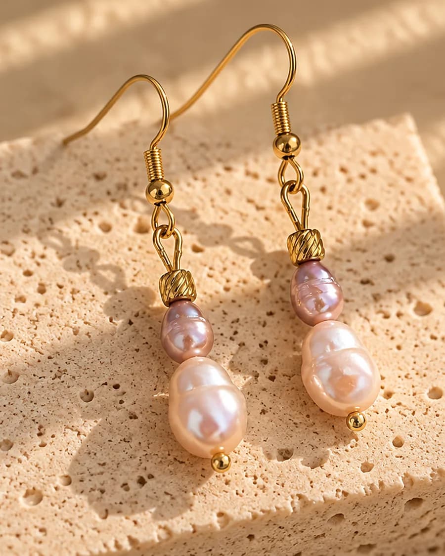 The Rosée Freshwater Pearl Drops photographed on a travertine block in warm daylight