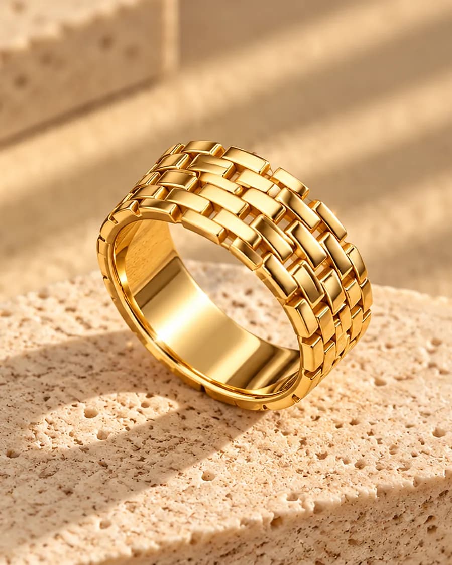 The Tressé Ring photographed on a travertine block in warm daylight