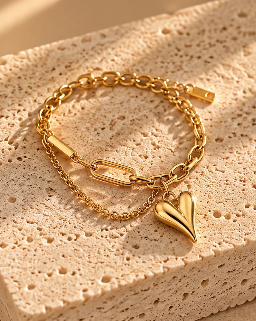 Amour Link Bracelet photographed on a travertine block in warm daylight