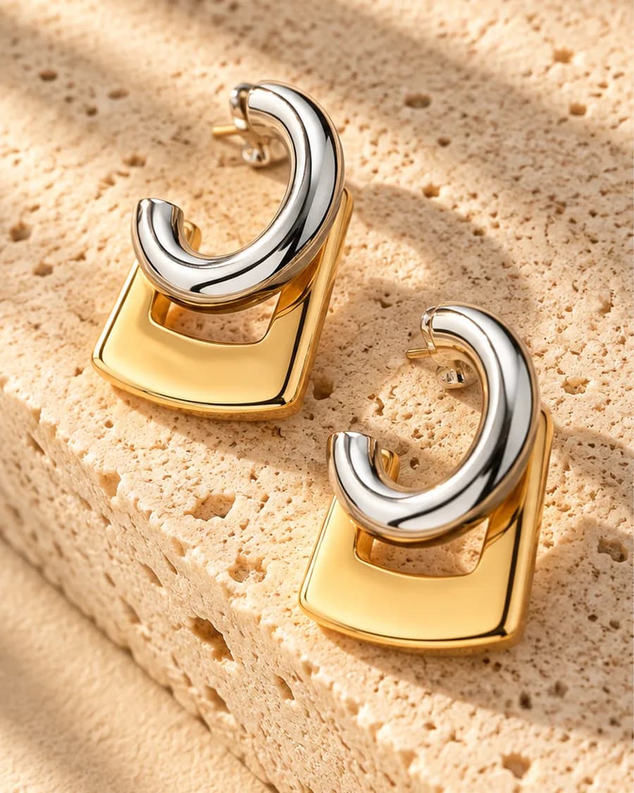 Luna Frame Drops photographed on a travertine block in warm daylight