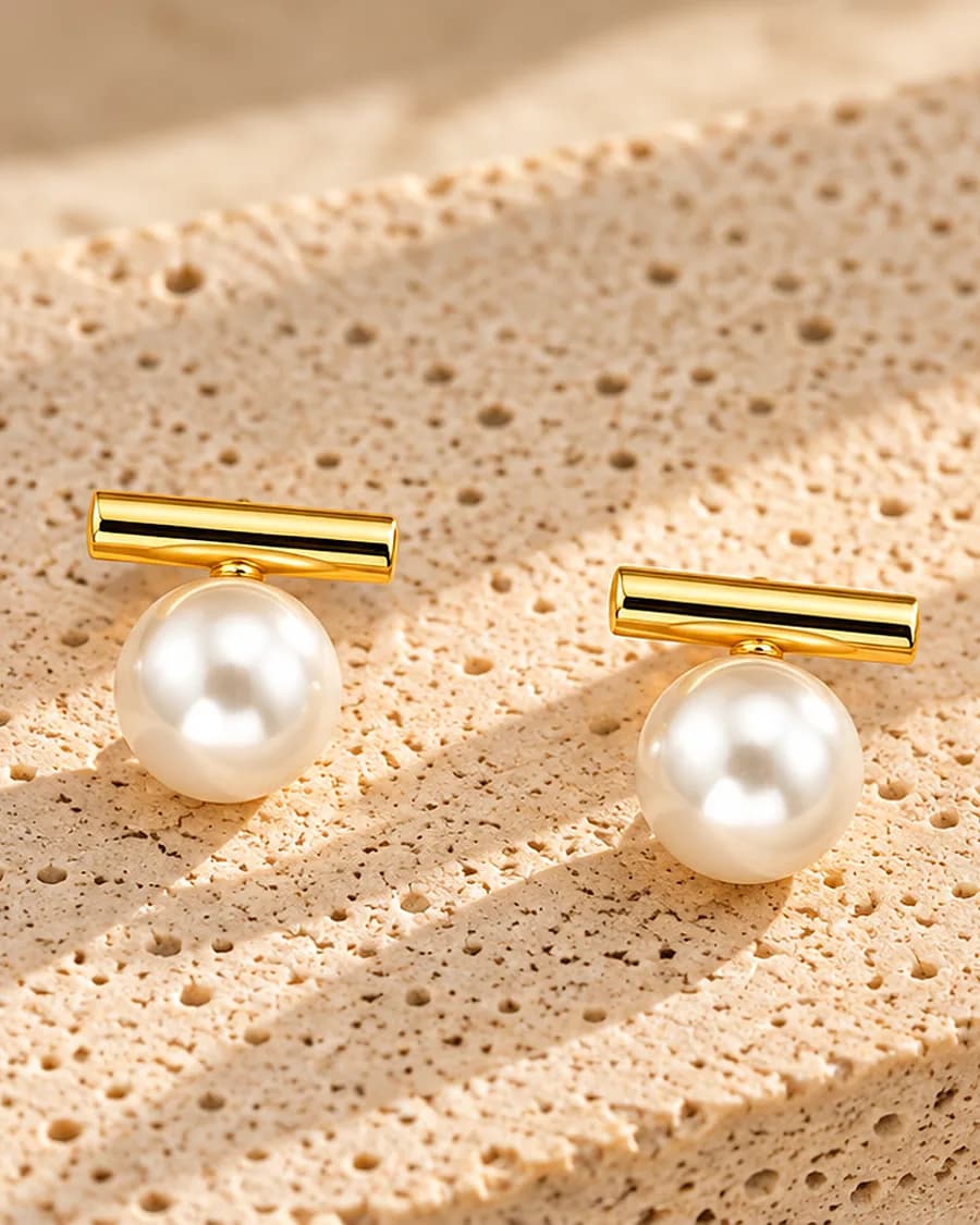 Pearl Bar Stud photographed on a travertine block in warm daylight