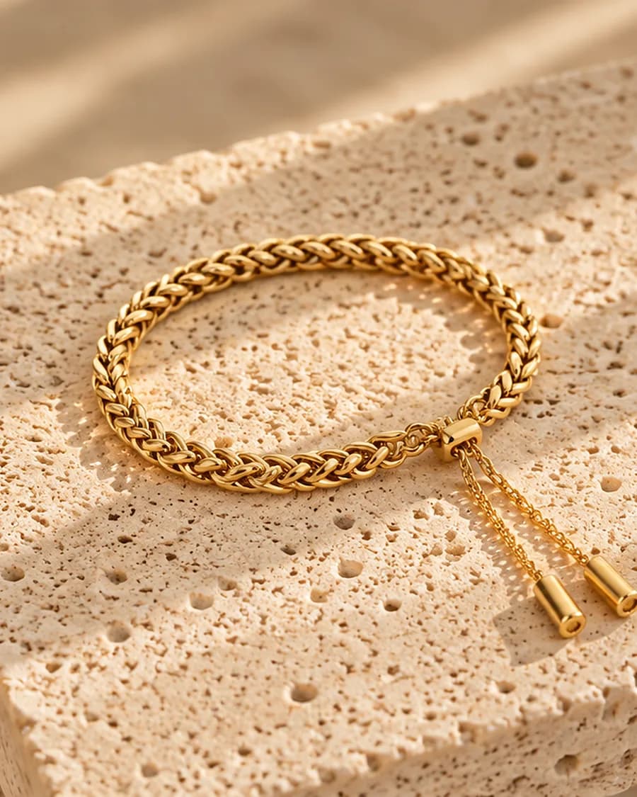 Riviera Chain Bracelet photographed on a travertine block in warm daylight