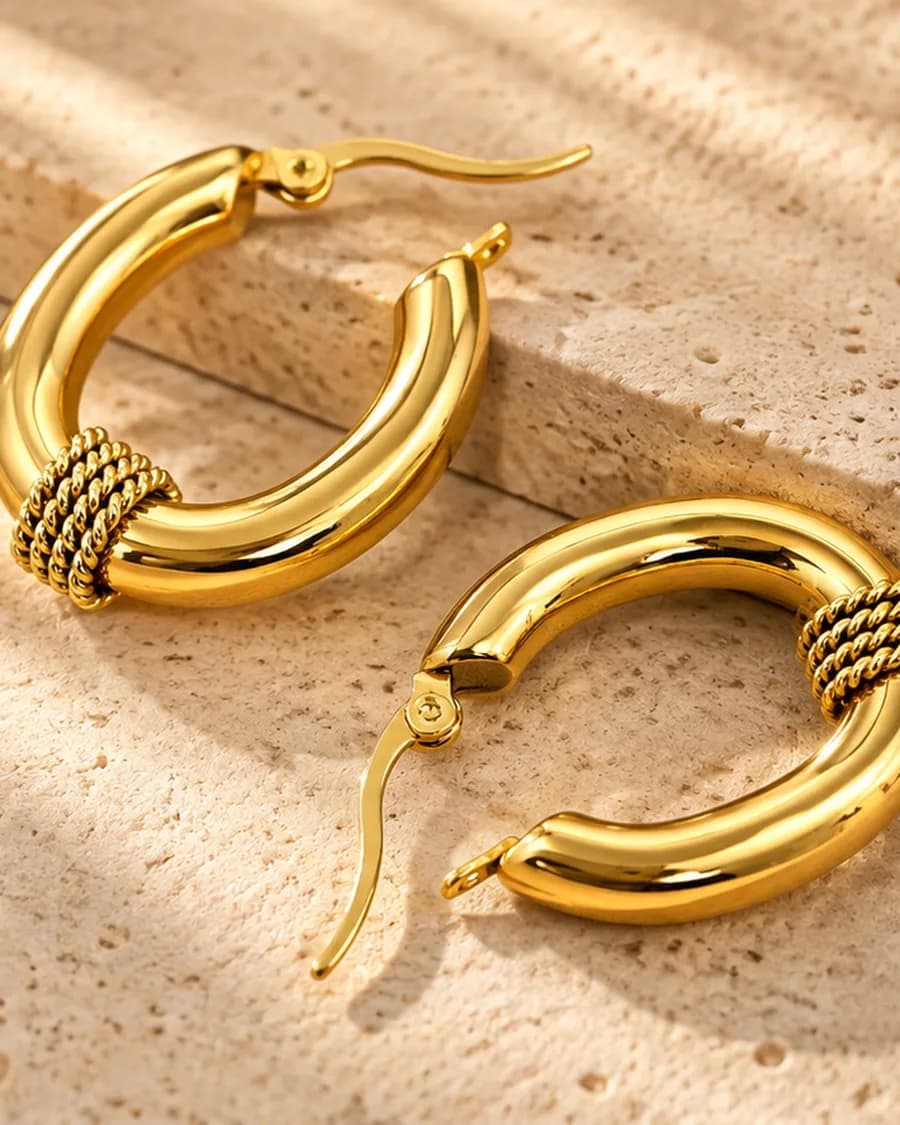 Sienna Hoops photographed on a travertine block in warm daylight