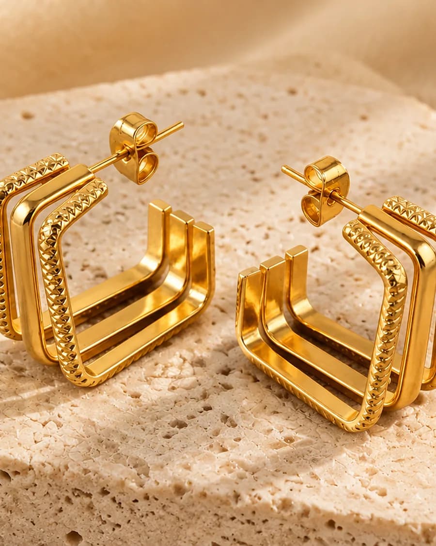 The Cadre Hoops photographed on a travertine block in warm daylight