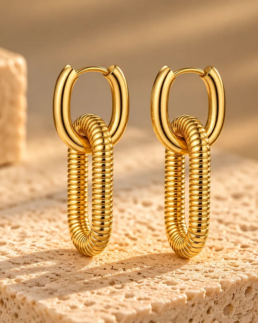 The Interlock Hoops photographed on a travertine block in warm daylight