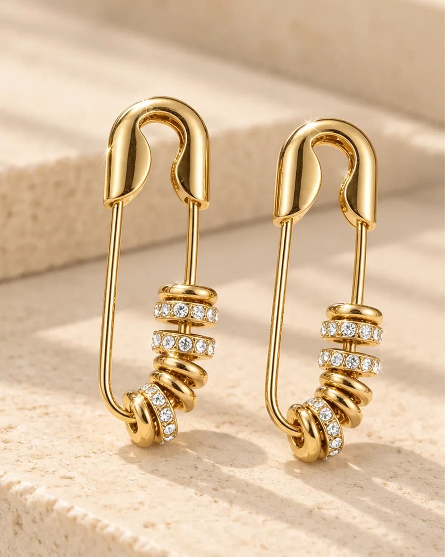 Vera Pin Earrings photographed on a travertine block in warm daylight