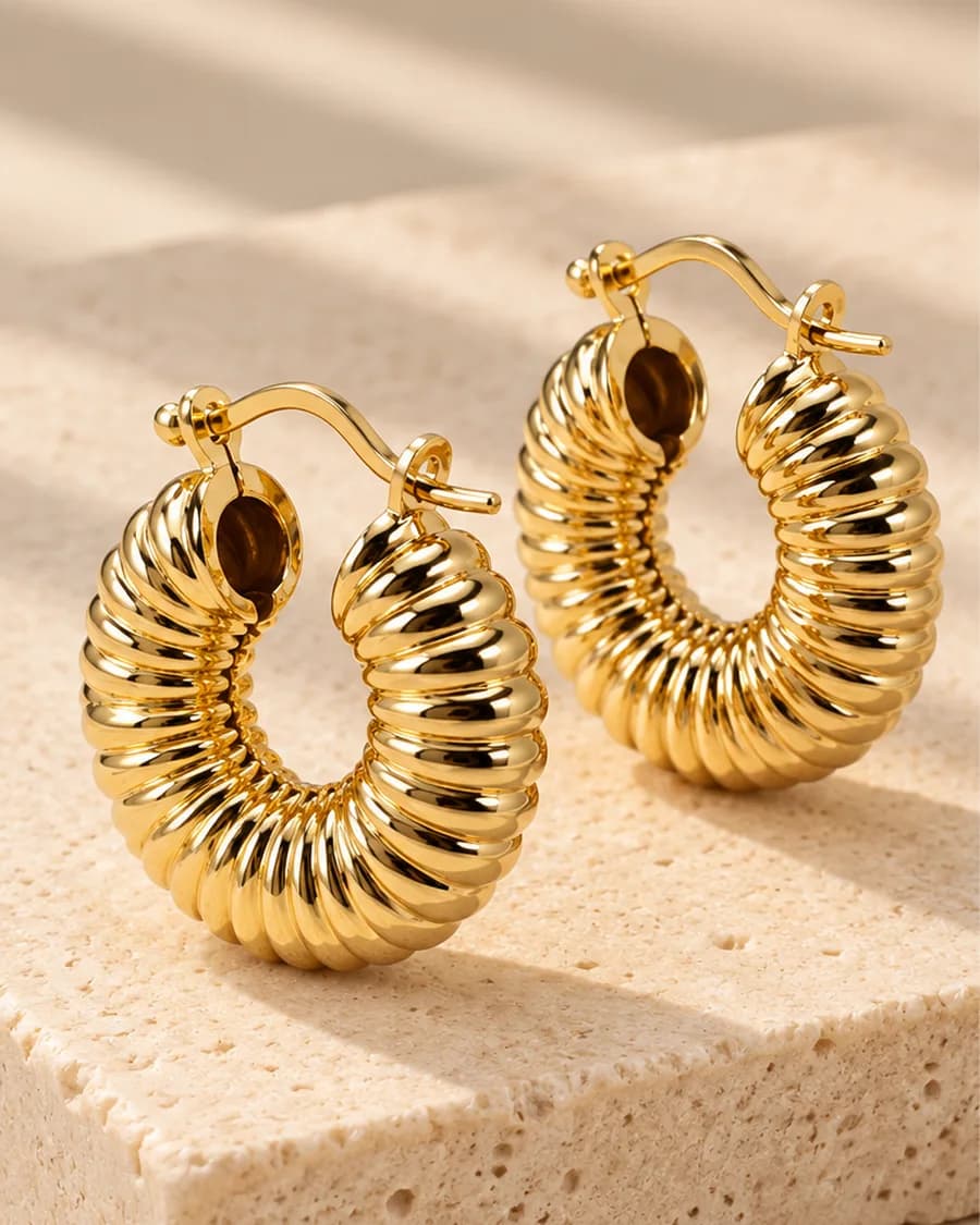 Zaria Hoops photographed on a travertine block in warm daylight